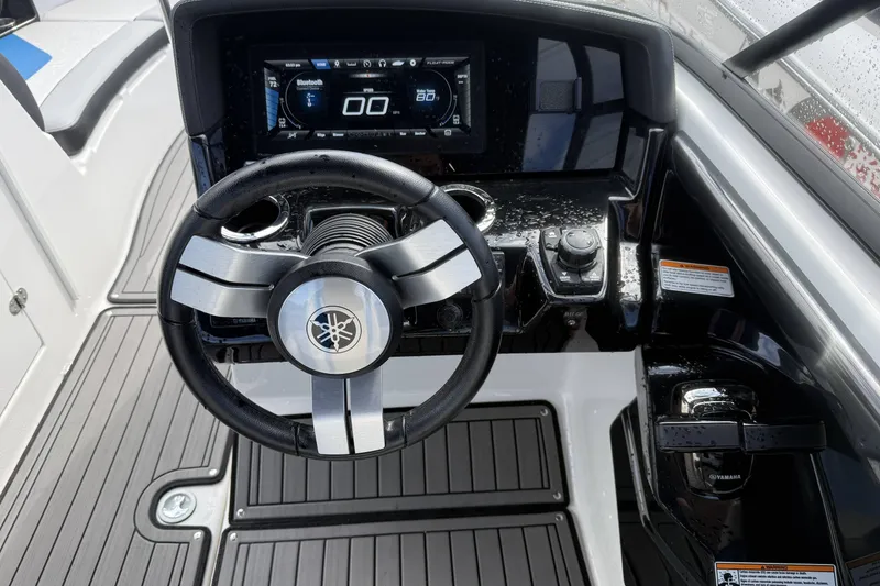 Slide: The Image of Open storage compartment on 2018 Yamaha Boats 242X E-Series, featuring sleek interior design. - 14