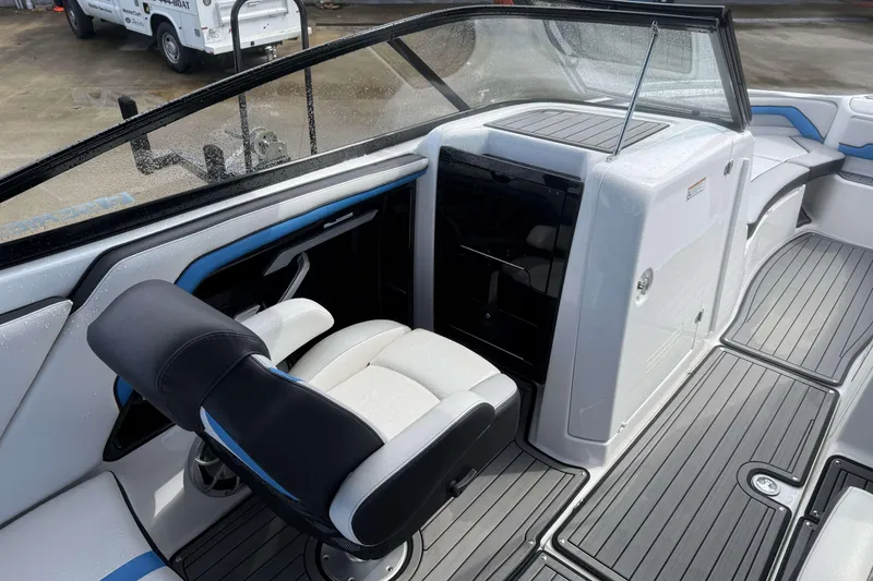 Slide: The Image of Interior view of a 2018 Yamaha Boats 242X E-Series, showing wiring and storage compartment. - 18