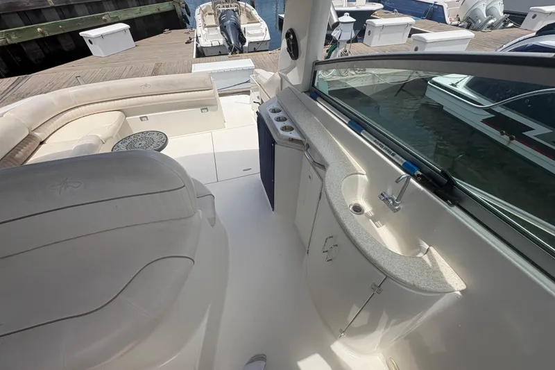 Slide: The Image of 2000 Monterey 322 Cruiser interior with seating and kitchenette at dock. - 11