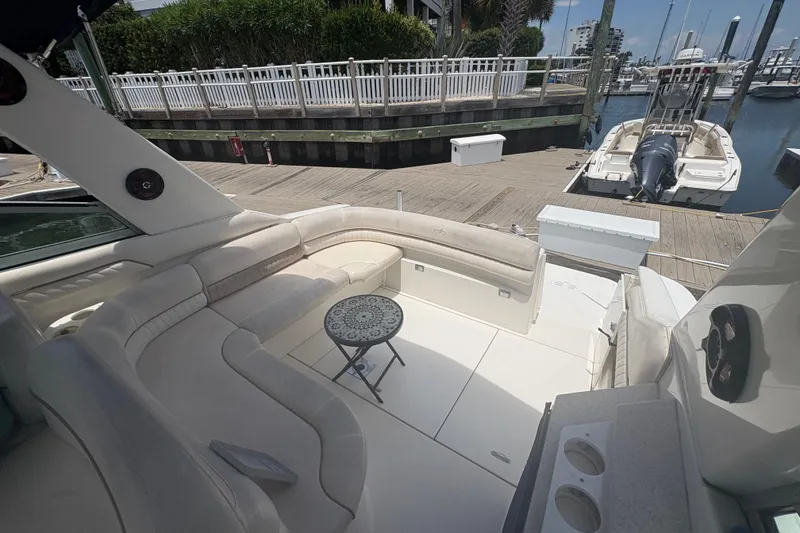 Slide: The Image of Luxurious seating area on a 2000 Monterey 322 Cruiser docked at a marina. - 12