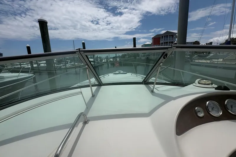 Slide: The Image of 2000 Monterey 322 Cruiser boat dashboard view at marina under cloudy sky. - 14
