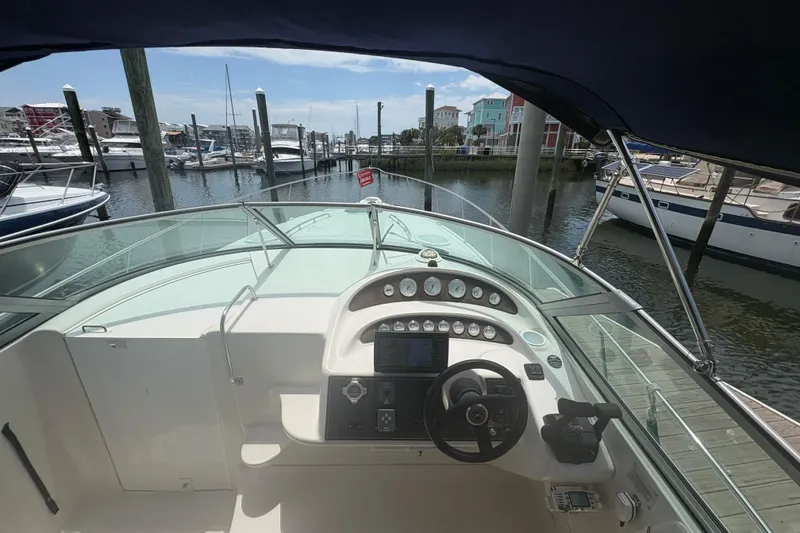 Slide: The Image of Cockpit view of a 2000 Monterey 322 Cruiser docked at a marina. - 15