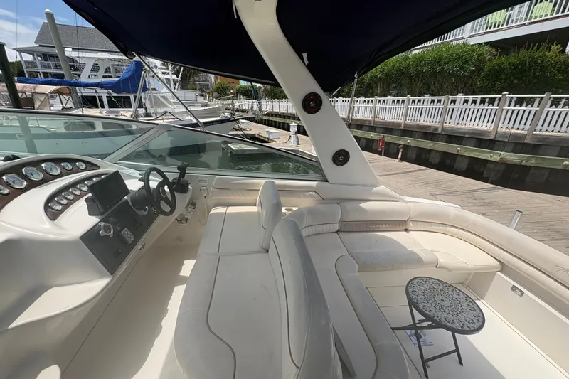 Slide: The Image of 2000 Monterey 322 Cruiser interior with helm, seating, and dockside view. - 20
