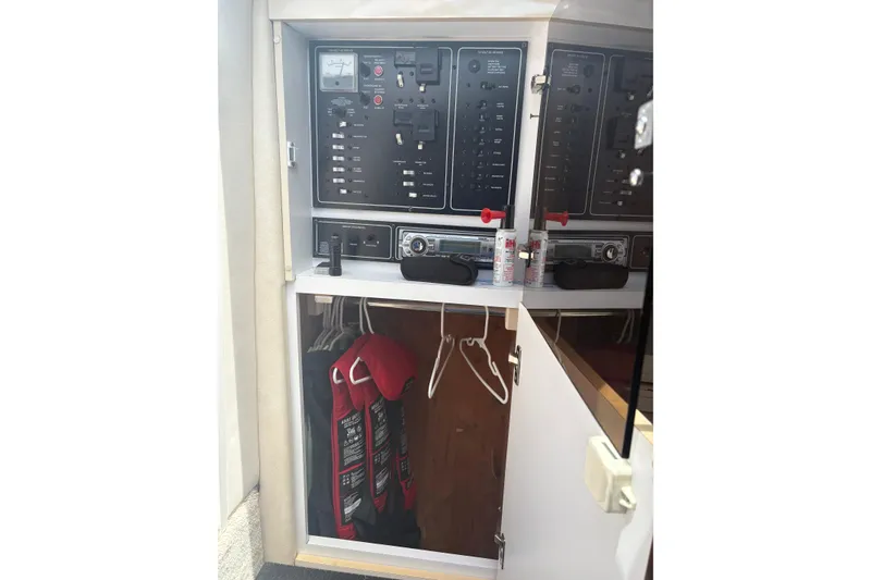 Slide: The Image of Electrical panel and storage area inside a 2000 Monterey 322 Cruiser boat. - 22