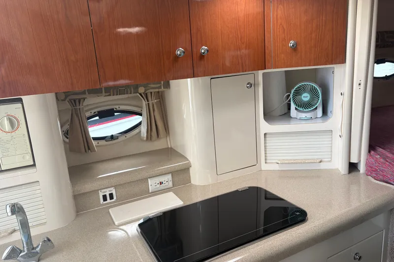 Slide: The Image of Interior of a 2000 Monterey 322 Cruiser kitchen with wooden cabinets and modern appliances. - 24