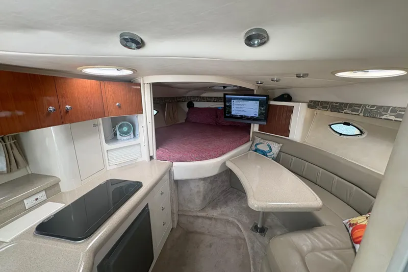 Slide: The Image of Interior of 2000 Monterey 322 Cruiser with kitchenette, seating, and sleeping area. - 27