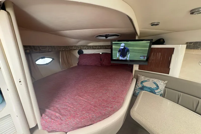 Slide: The Image of Interior of 2000 Monterey 322 Cruiser with bed, TV, and nautical decor. - 28