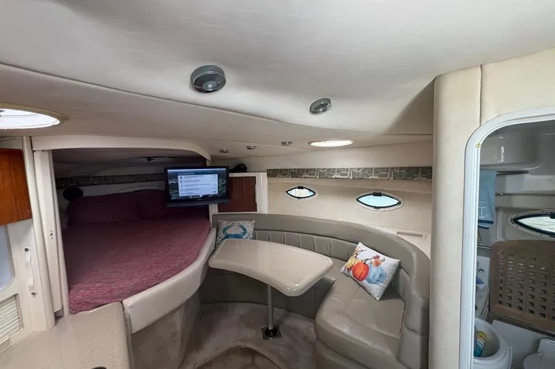 Slide: The Image of Interior of 2000 Monterey 322 Cruiser with cozy seating and small table. - 29