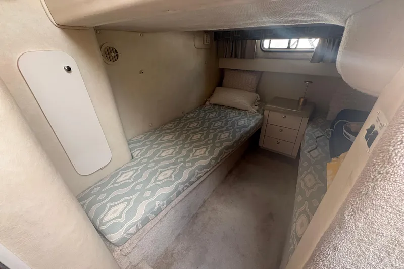 Slide: The Image of Cozy cabin interior of 2000 Monterey 322 Cruiser with twin beds and storage. - 31