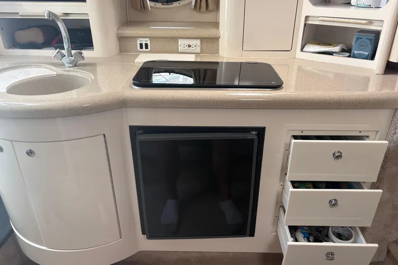 Slide: The Image of Interior of a 2000 Monterey 322 Cruiser featuring a compact kitchen area. - 35