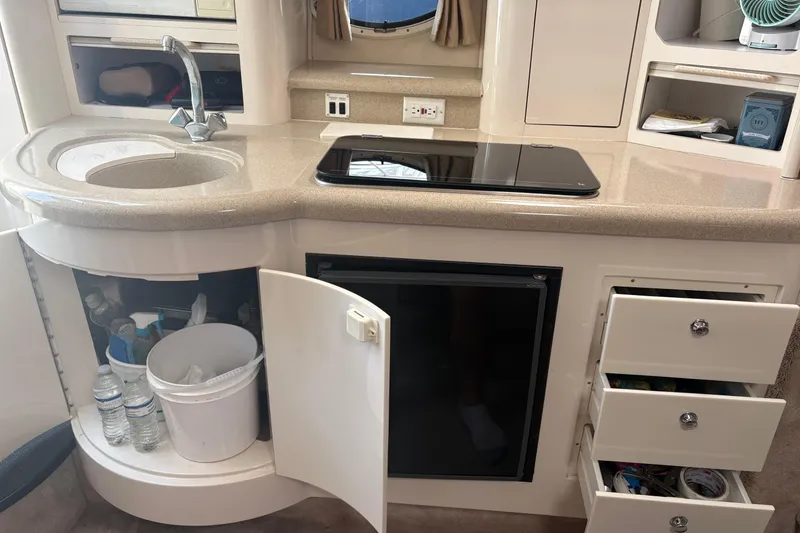 Slide: The Image of Compact kitchen area in a 2000 Monterey 322 Cruiser with sink, stove, and storage. - 36