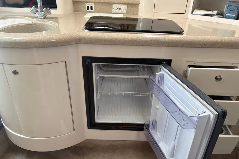 Slide: The Image of Interior of 2000 Monterey 322 Cruiser with open mini fridge and countertop. - 37