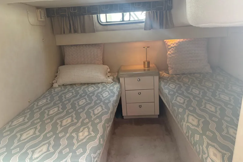 Slide: The Image of Cozy cabin interior of 2000 Monterey 322 Cruiser with twin beds and elegant decor. - 38