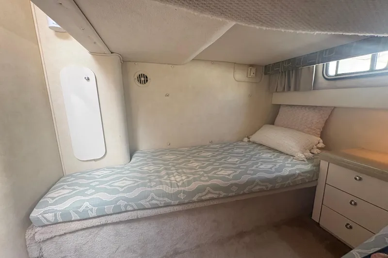 Slide: The Image of Cozy cabin interior of 2000 Monterey 322 Cruiser with bed and storage drawers. - 40