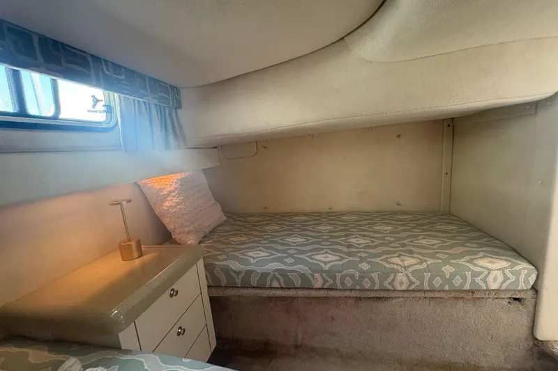 Slide: The Image of Interior cabin of 2000 Monterey 322 Cruiser with cozy bed and soft lighting. - 41