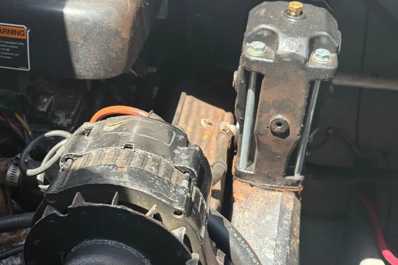 Slide: The Image of Engine components of a 2000 Monterey 322 Cruiser, showing alternator and mounting bracket. - 46