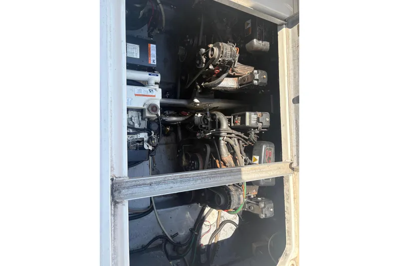 Slide: The Image of Engine compartment of a 2000 Monterey 322 Cruiser boat, showcasing mechanical components. - 47