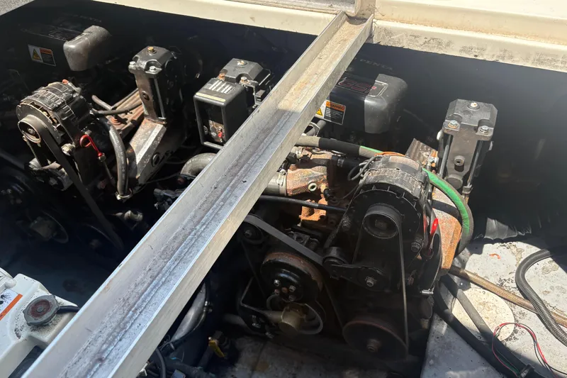 Slide: The Image of Engine compartment of a 2000 Monterey 322 Cruiser boat, showing mechanical components and belts. - 49