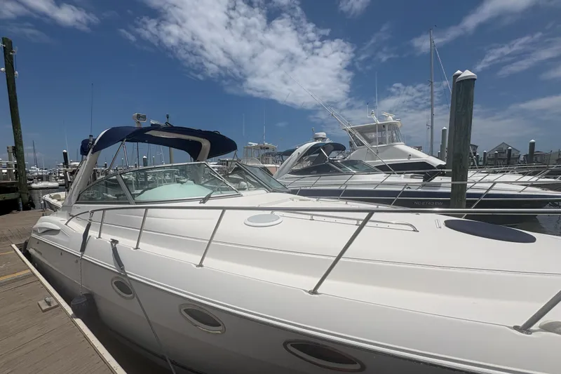 Slide: The Image of 2000 Monterey 322 Cruiser docked at marina under blue sky. - 5