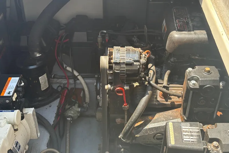Slide: The Image of Engine compartment of a 2000 Monterey 322 Cruiser boat, showing mechanical components and wiring. - 52
