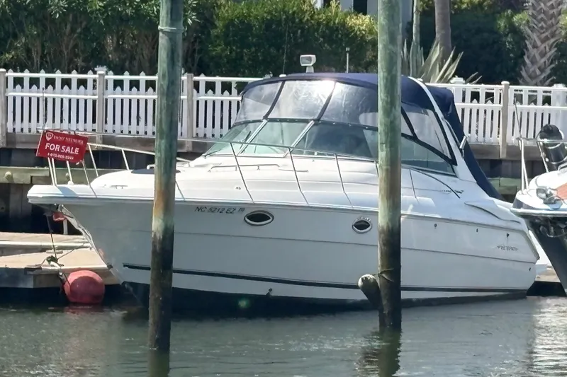 Slide: The Image of 2000 Monterey 322 Cruiser boat docked, for sale sign visible. - 56