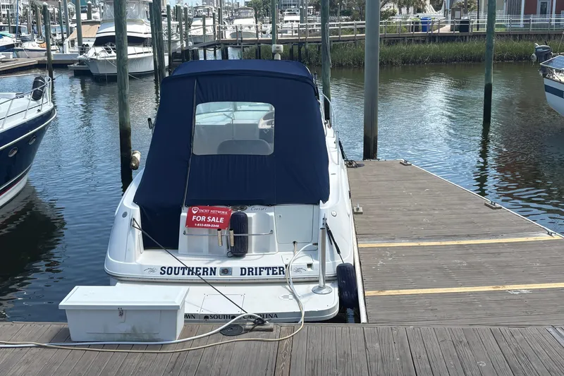 Slide: The Image of 2000 Monterey 322 Cruiser docked, for sale sign displayed, marina background. - 57