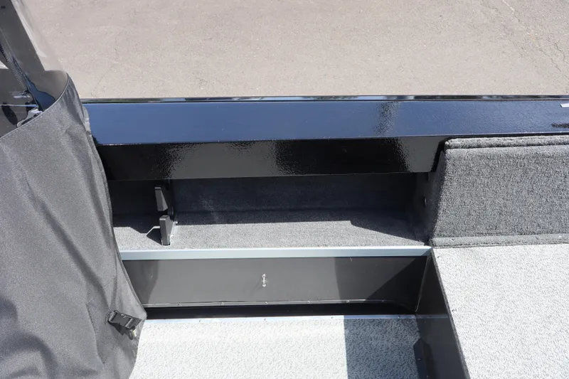 Slide: The Image of 2026 Smoker Craft Osprey 172 boat interior with carpeted flooring and storage compartment. - 10