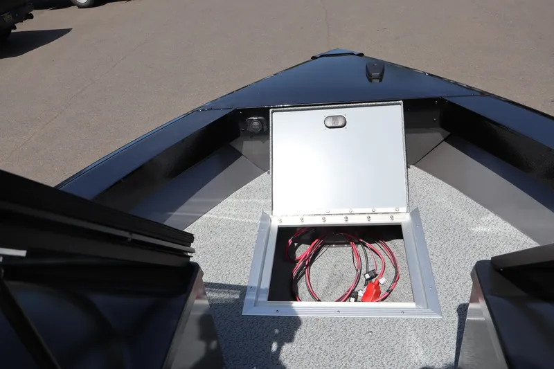 Slide: The Image of 2026 Smoker Craft Osprey 172 boat interior with open storage compartment and visible wiring. - 20