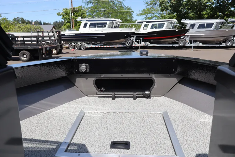 Slide: The Image of 2026 Smoker Craft Osprey 172 boat interior with docked vessels in the background. - 21