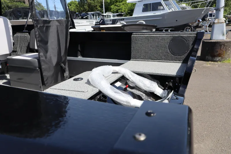 Slide: The Image of 2026 Smoker Craft Osprey 172 boat interior with seating and wrapped equipment. - 5