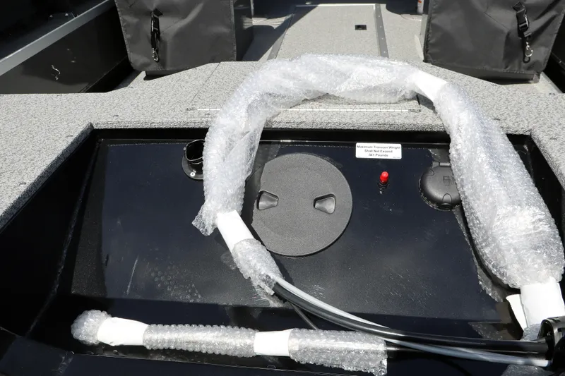 Slide: The Image of 2026 Smoker Craft Osprey 172 boat interior with wrapped components and control panel. - 6