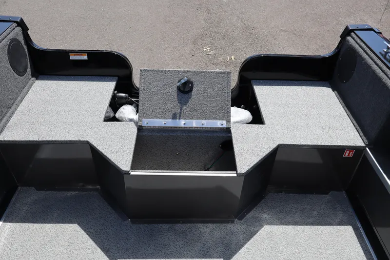 Slide: The Image of 2026 Smoker Craft Osprey 172 boat interior with gray carpeted storage compartments. - 8
