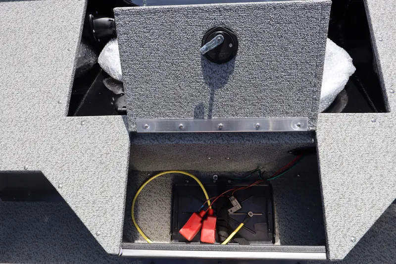 Slide: The Image of 2026 Smoker Craft Osprey 172 boat battery compartment with wiring and storage. - 9