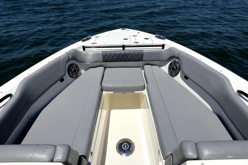 Slide: The Image of 2024 Cobia 280 Dual Console boat interior with gray seating and ocean view. - 11