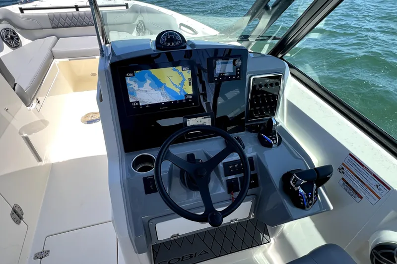 Slide: The Image of 2024 Cobia 280 Dual Console boat dashboard with navigation system and controls. - 18