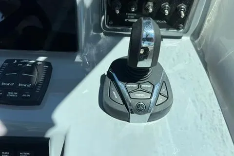 Slide: The Image of 2024 Cobia 280 Dual Console boat control panel with joystick and buttons. - 20