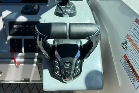 Slide: The Image of 2024 Cobia 280 Dual Console boat throttle controls and dashboard. - 21