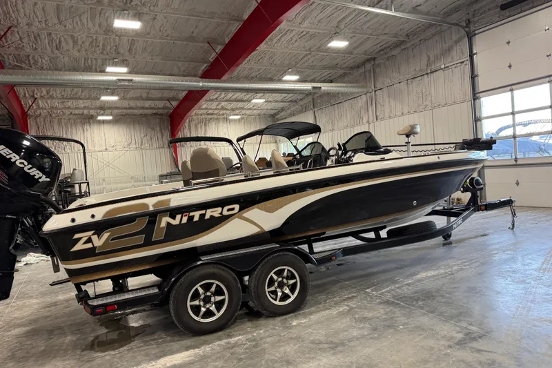 Slide: The Image of 2014 Nitro ZV21 boat in a garage, featuring a sleek black and white design. - 2