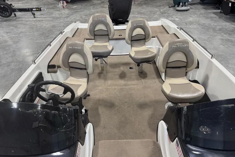 Slide: The Image of 2014 Nitro ZV21 boat interior with four seats and steering wheel in a showroom. - 7