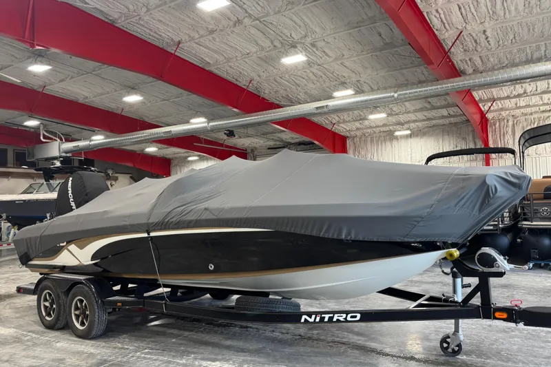 Slide: The Image of 2014 Nitro ZV21 boat covered in a garage, resting on a trailer. - 9
