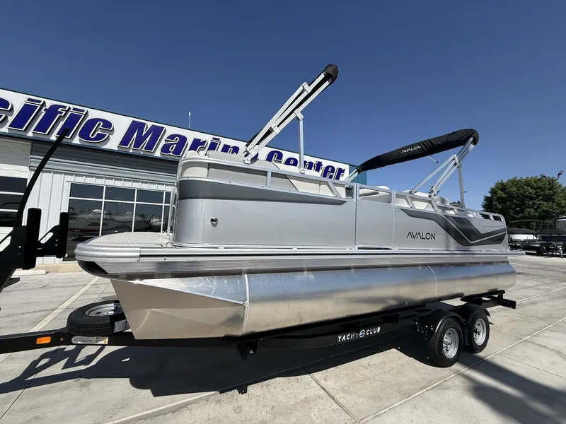 Slide: The Image of 2026 Avalon Venture Versatile pontoon boat at marine center. - 2