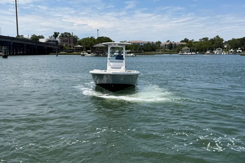Slide: The Image of 2017 Everglades 243 Center Console boat cruising on a scenic waterway. - 10