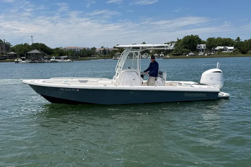Slide: The Image of 2017 Everglades 243 Center Console boat on water, with person at helm. - 11