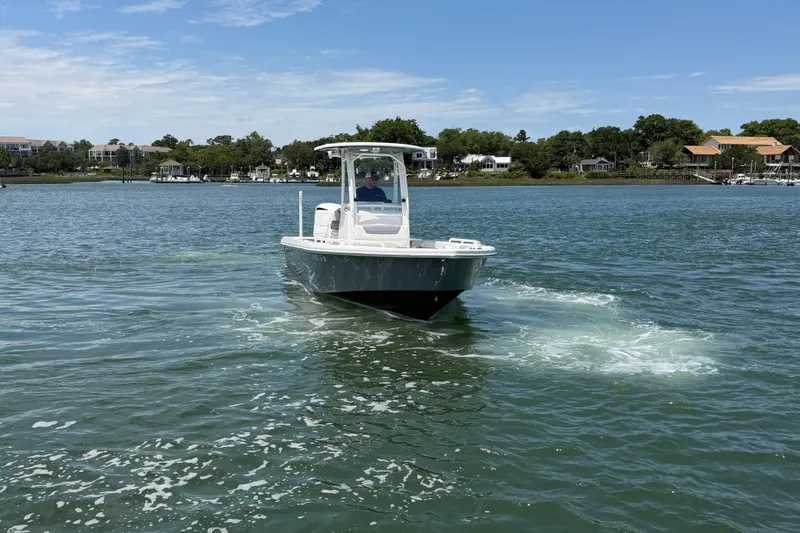 Slide: The Image of 2017 Everglades 243 Center Console boat cruising on a scenic waterway. - 14