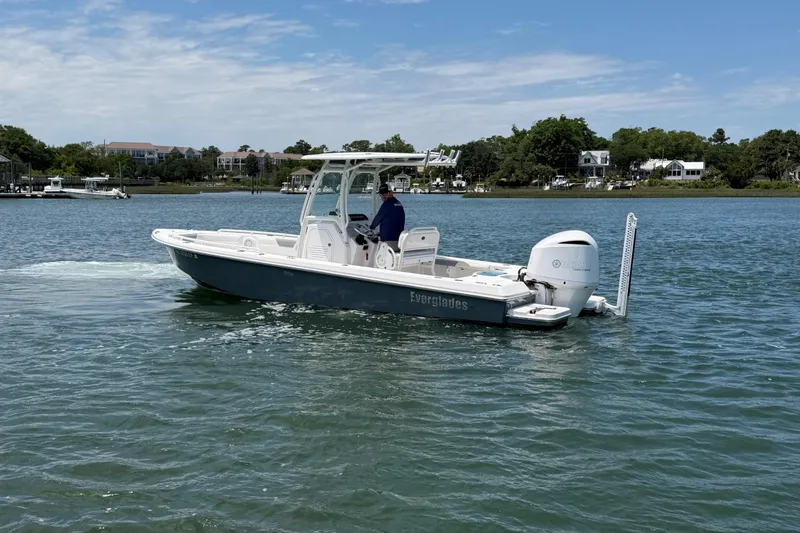 Slide: The Image of 2017 Everglades 243 Center Console boat cruising on a calm lake. - 15