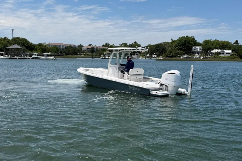 Slide: The Image of 2017 Everglades 243 Center Console boat cruising on a scenic waterway. - 16