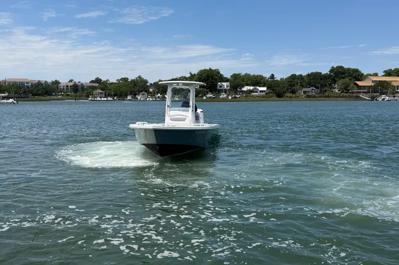 Slide: The Image of 2017 Everglades 243 Center Console boat cruising on a scenic waterway. - 17