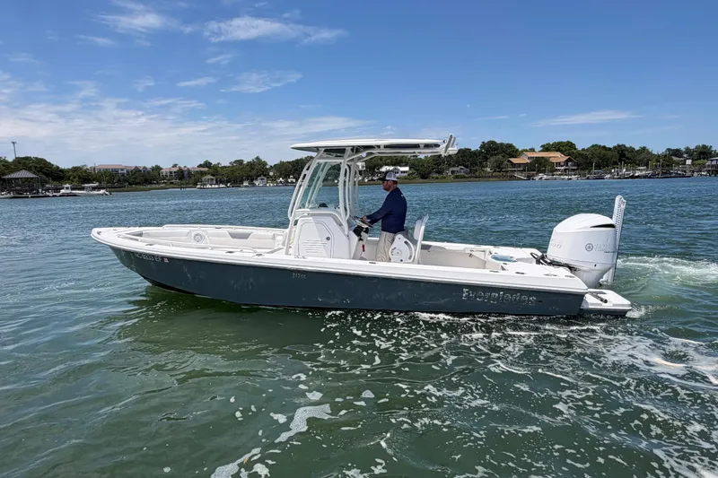 Slide: The Image of 2017 Everglades 243 Center Console boat cruising on a sunny day. - 19