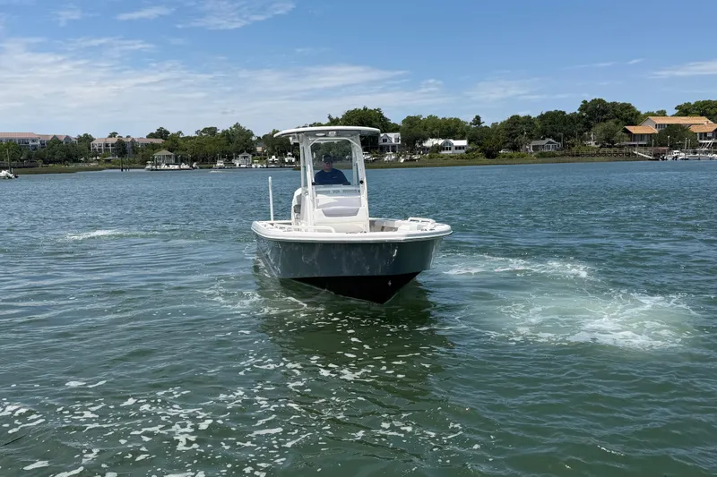 Slide: The Image of 2017 Everglades 243 Center Console boat cruising on a scenic waterway. - 23