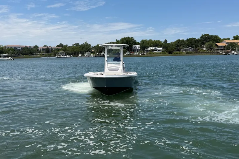 Slide: The Image of 2017 Everglades 243 Center Console boat cruising on a scenic waterway. - 24